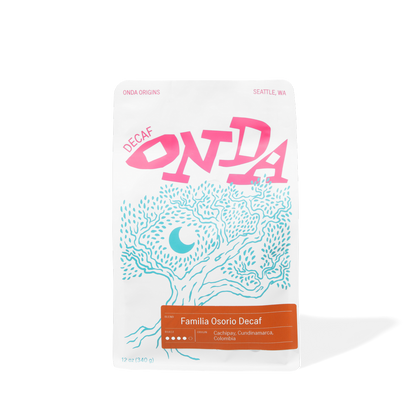 Decaf colombian coffee bag with pink and blue design on a white background single origins specialty coffee beans