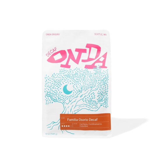 Decaf colombian coffee bag with pink and blue design on a white background single origins specialty coffee beans