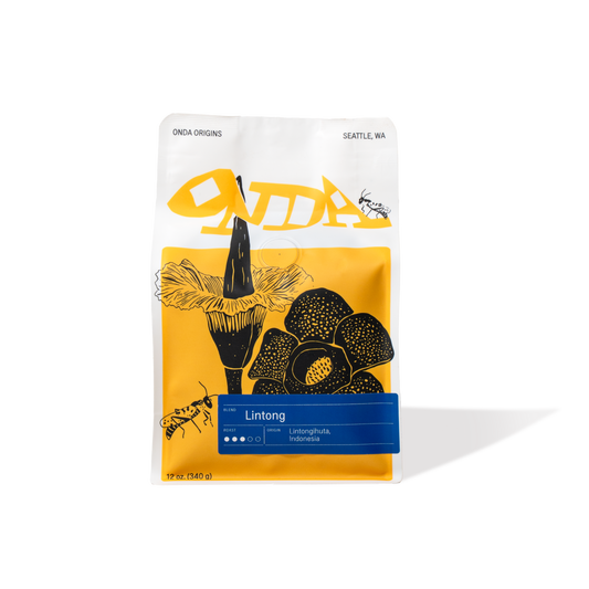 White coffee bag with yellow and black design, specialty coffee from Indonesia, single origin specialty coffee, medium roast whole bean coffee bag