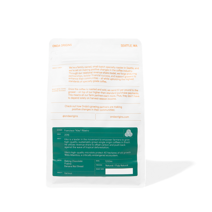 White product packaging with text and a green label on a white background. Single origin whole bean specialty coffee ethically sourced from Brazil
