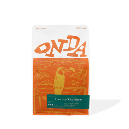 Orange and white package with 'ONDA' branding and a toucan illustration on a white background. Single origin coffee beans from brazil