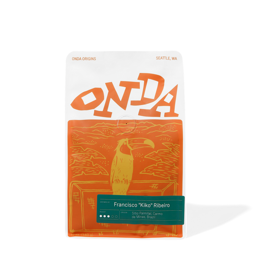 Orange and white package with 'ONDA' branding and a toucan illustration on a white background. Single origin coffee beans from brazil
